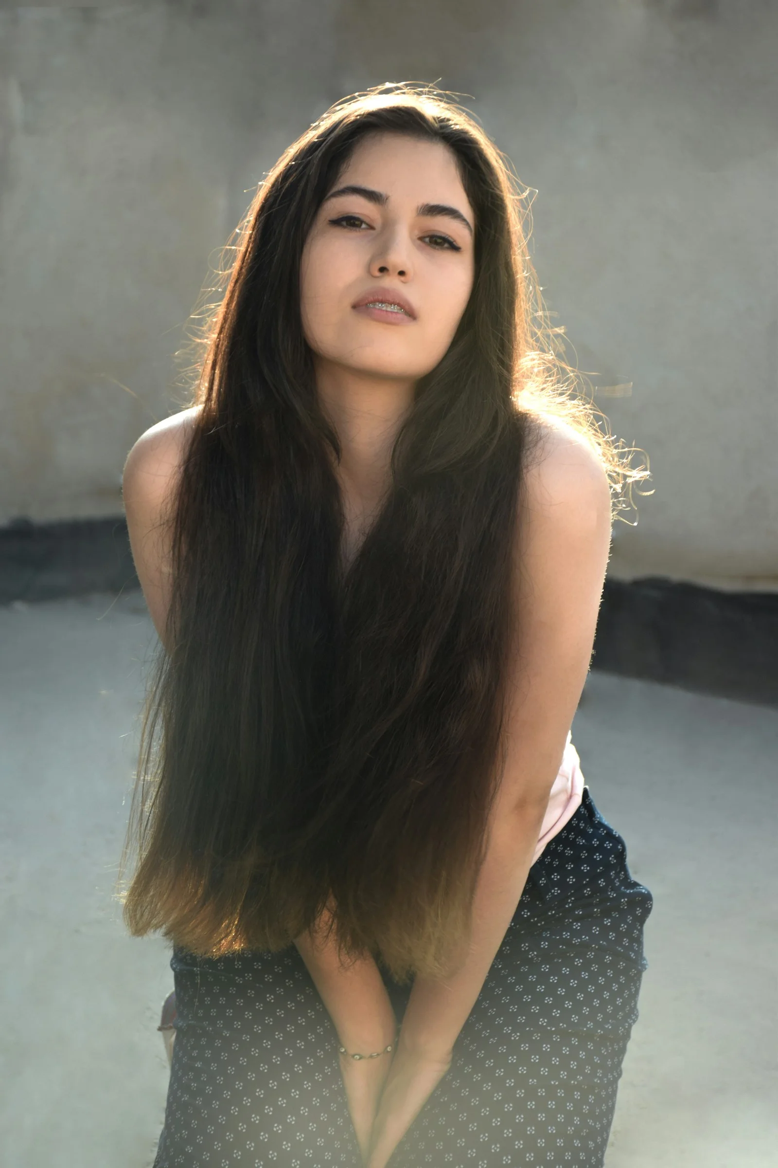 A woman with long hair is posing for a picture