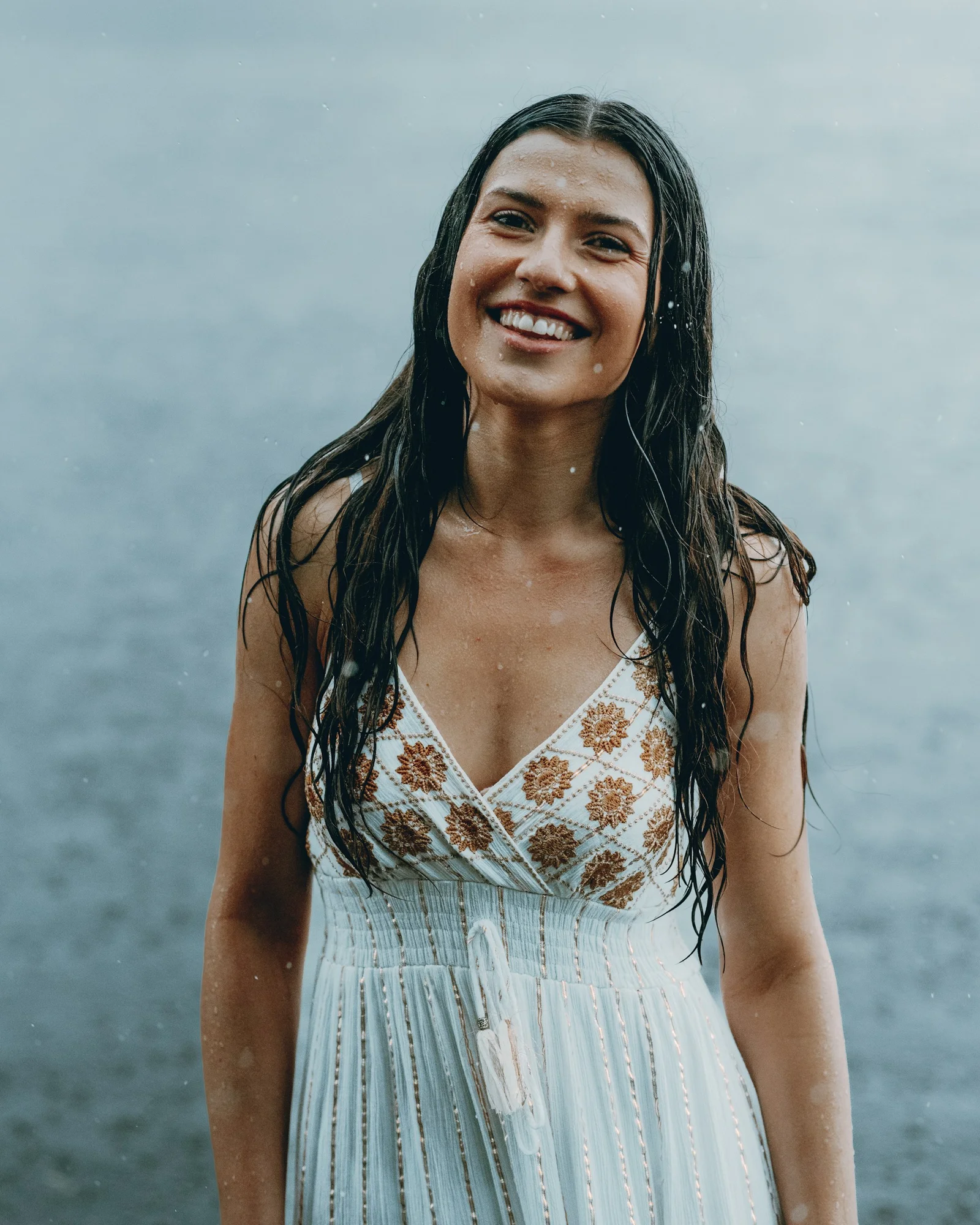 Woman smiles radiantly in the refreshing rain
