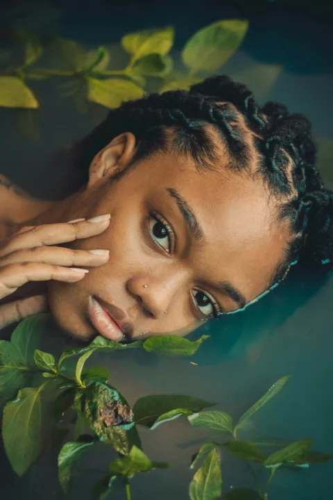 a woman with braids in a pool of water