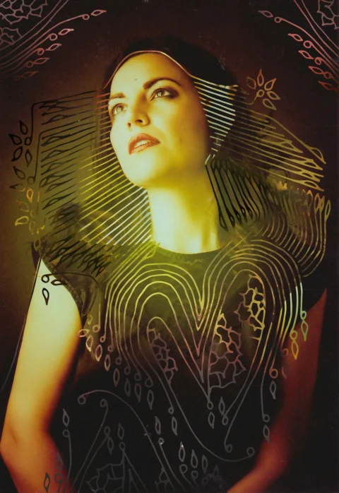 A woman in a black dress with a pattern on it