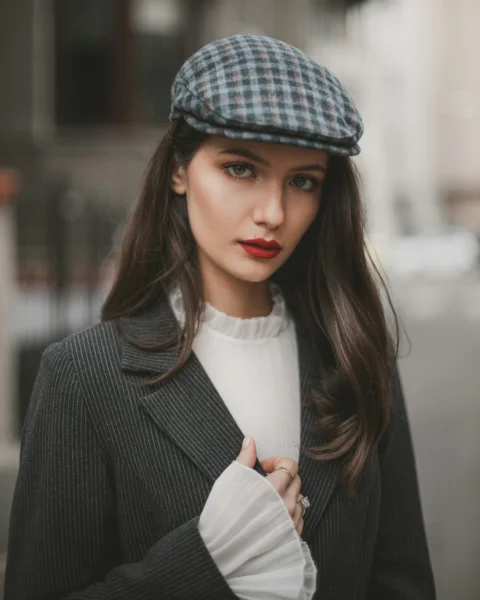 a woman wearing a hat and a jacket