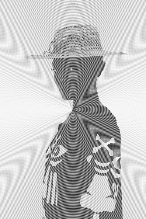 a black and white photo of a person wearing a hat