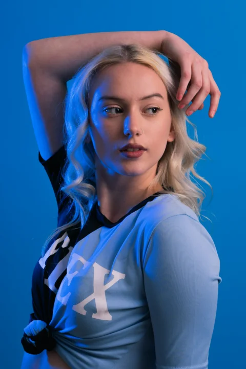 a woman with blonde hair is posing for a picture
