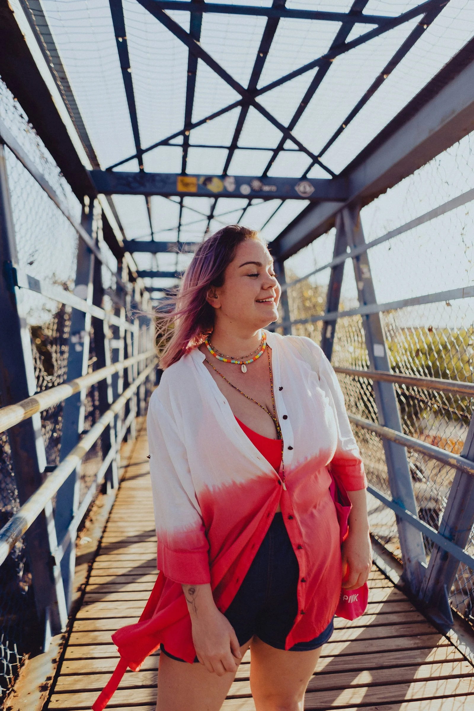 a woman standing on a bridge