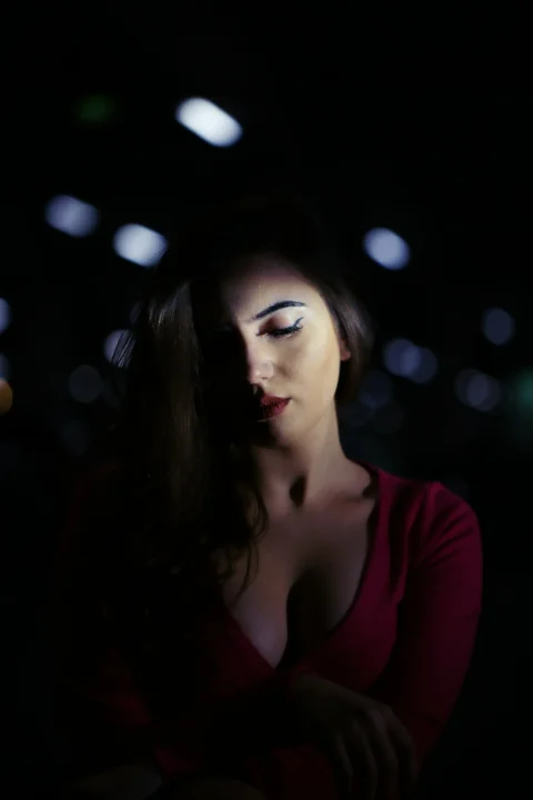 a woman in a red shirt is posing for a picture