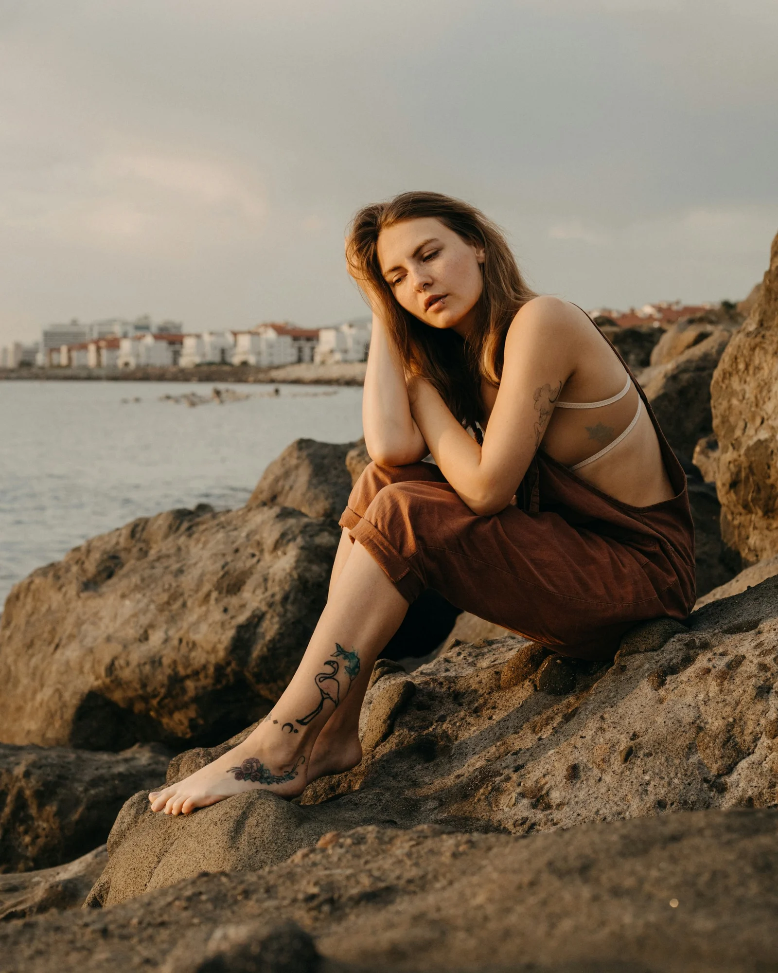 a woman sitting on a rock