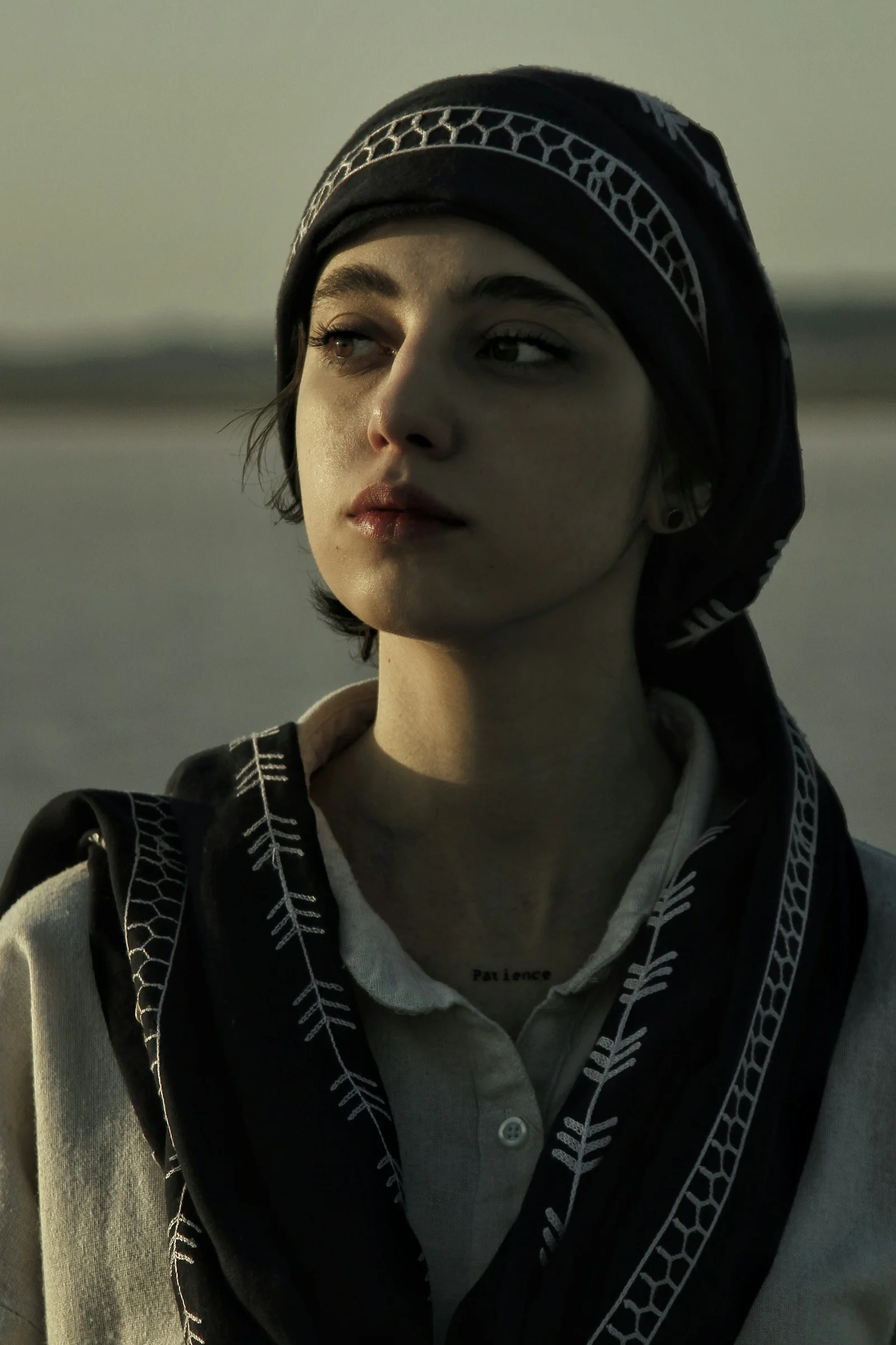 a woman wearing a black hat and scarf