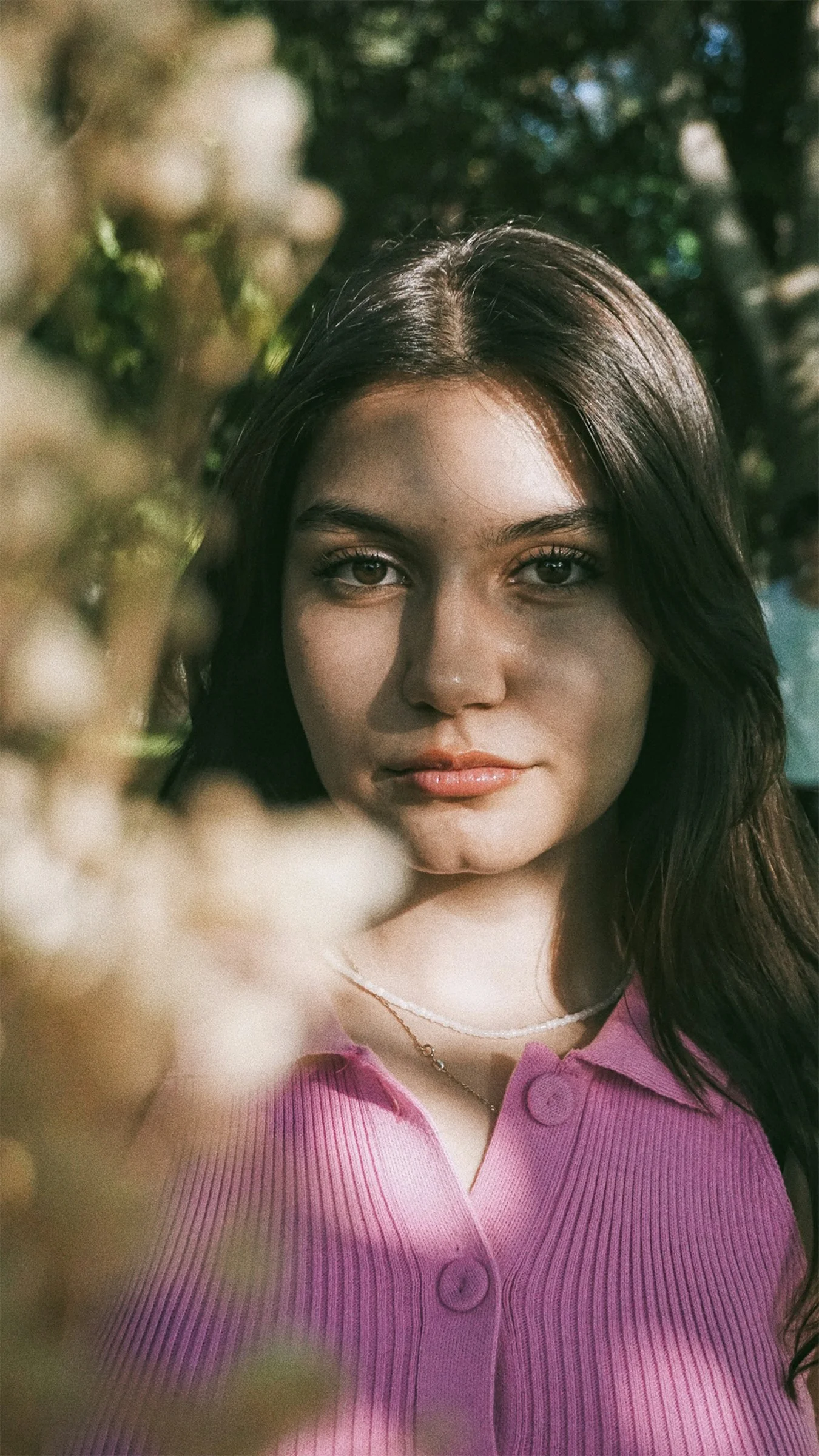 a woman in a pink shirt is posing for a picture