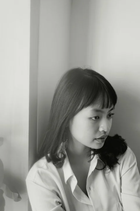 grayscale photo of woman in white shirt