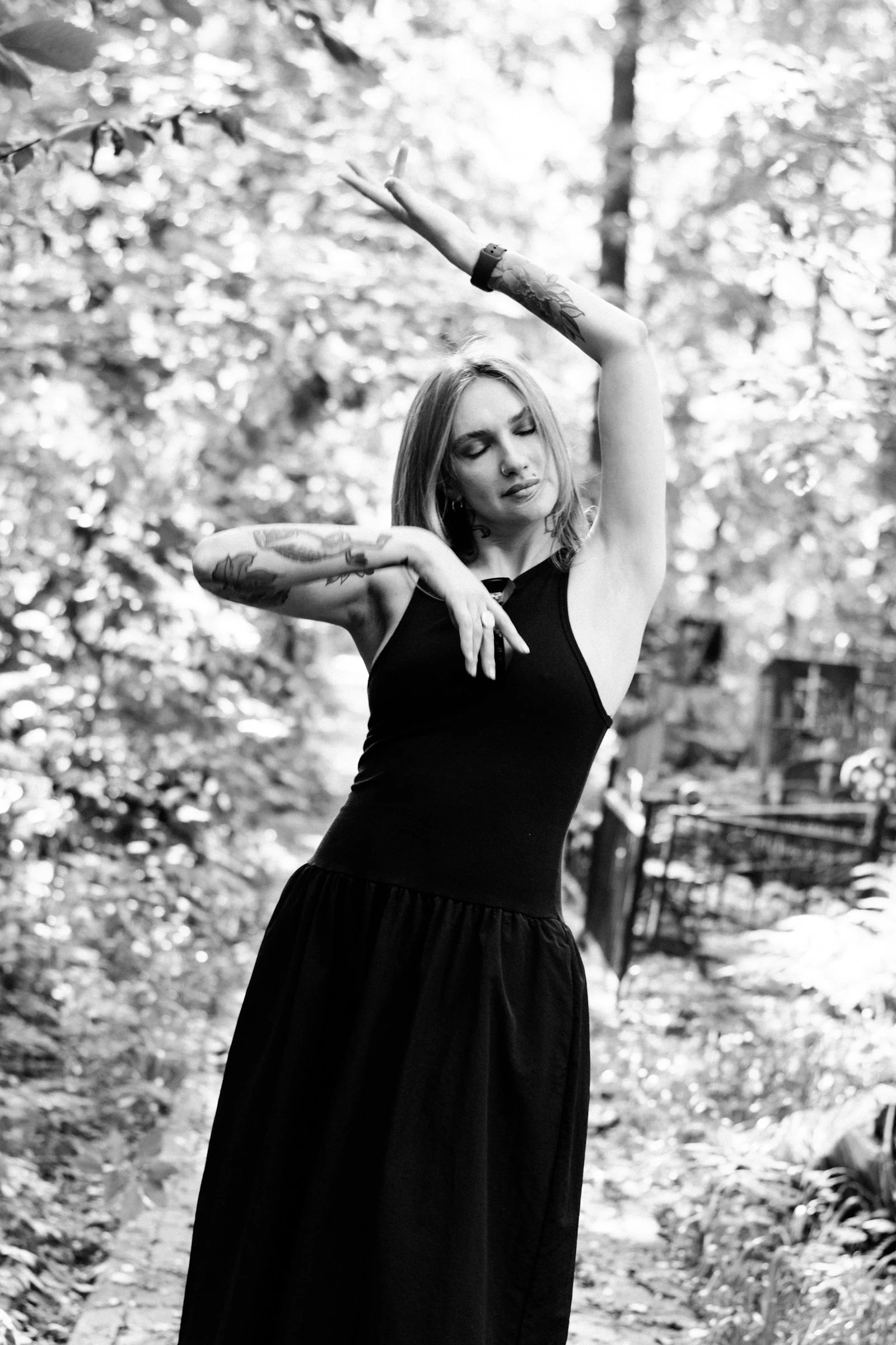 A woman dances gracefully in a forest