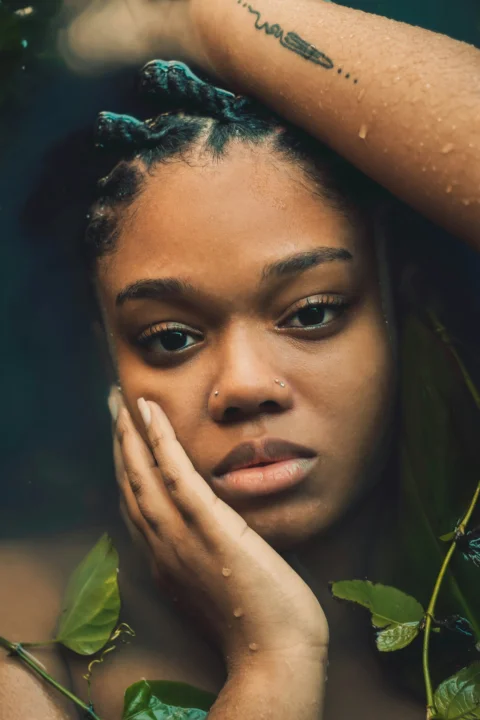 a close up of a person with a plant