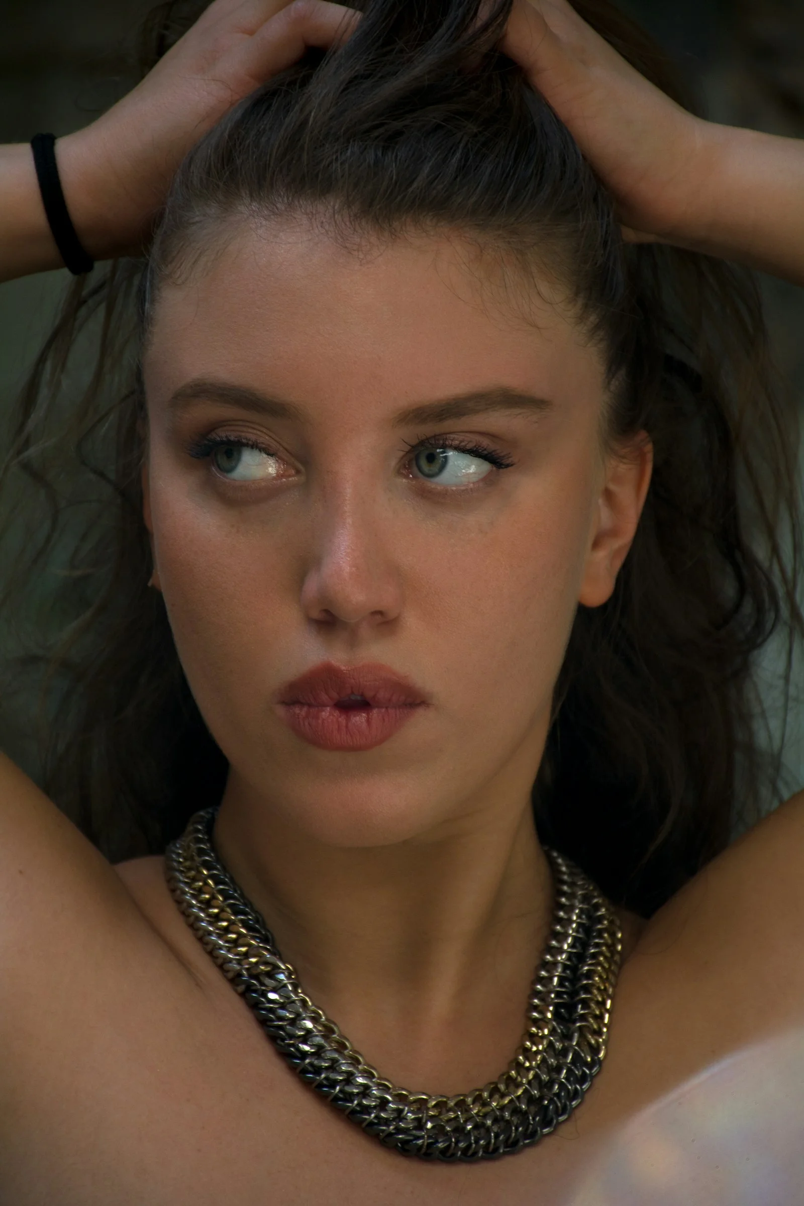 a close up of a person wearing a necklace