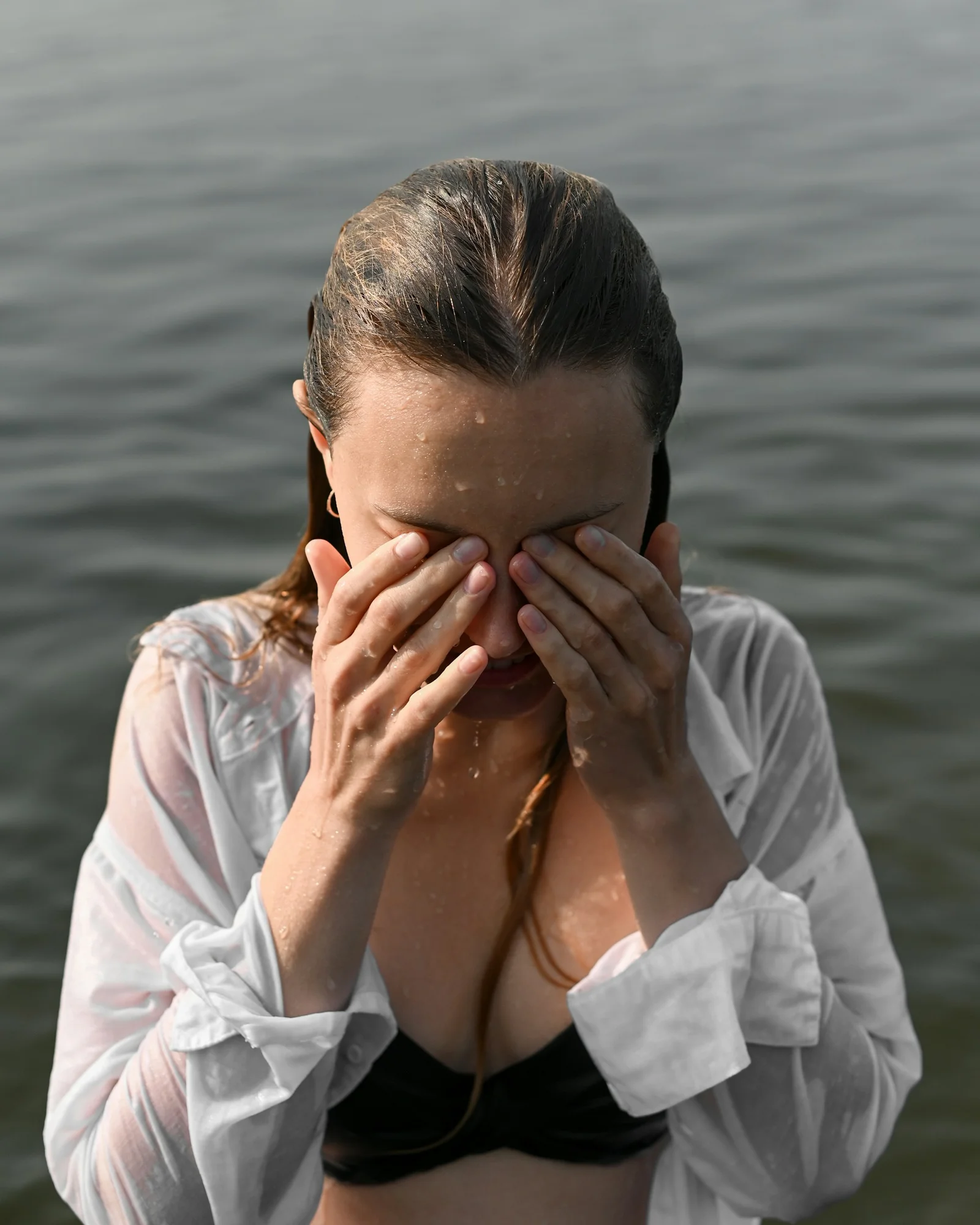 a person covering the face with the hands