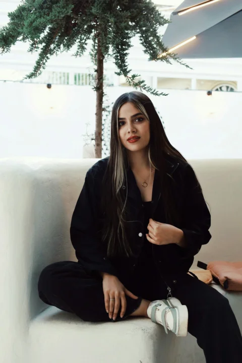A woman sitting on top of a white couch