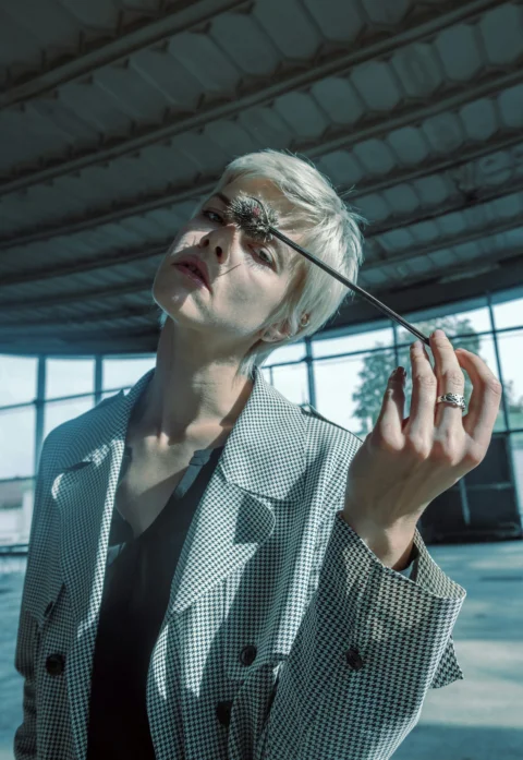 woman in white and black checkered button up shirt wearing sunglasses