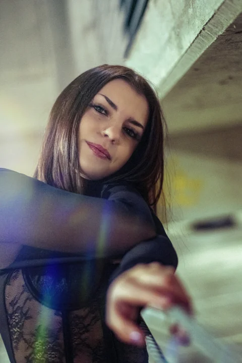 a woman is posing for a picture while holding a cell phone