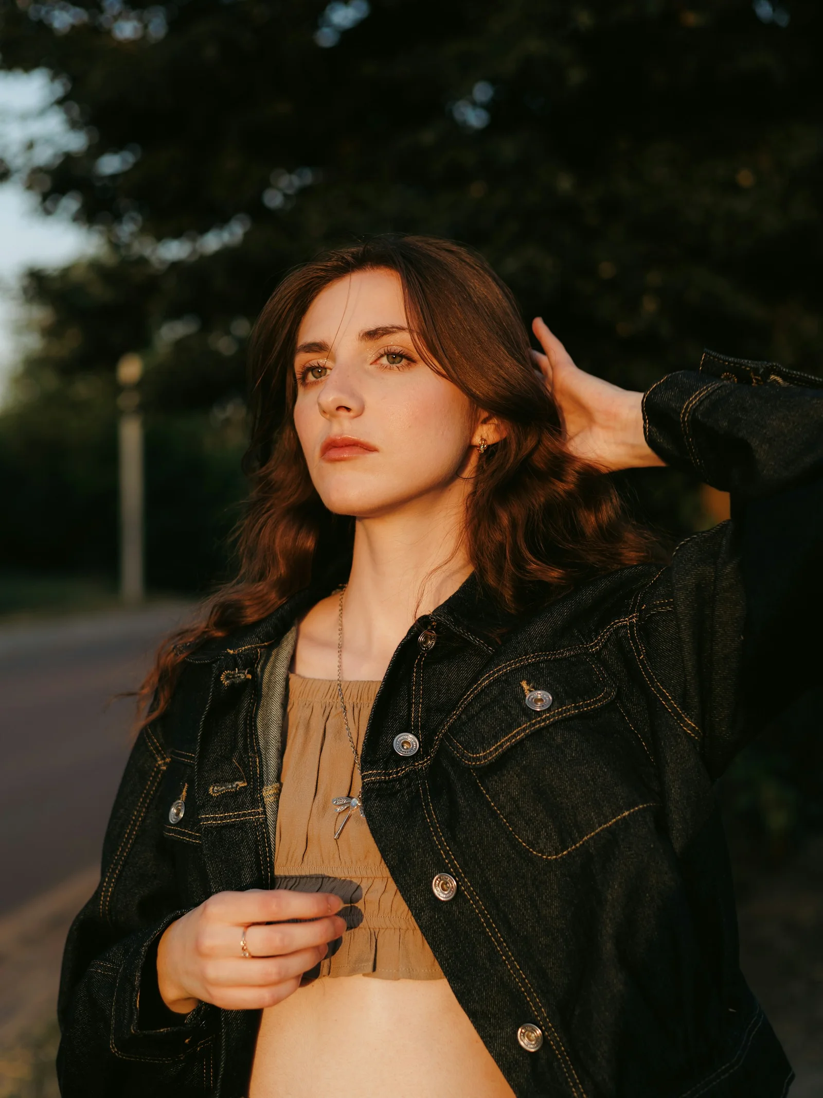 Young woman with long hair in golden hour sunlight