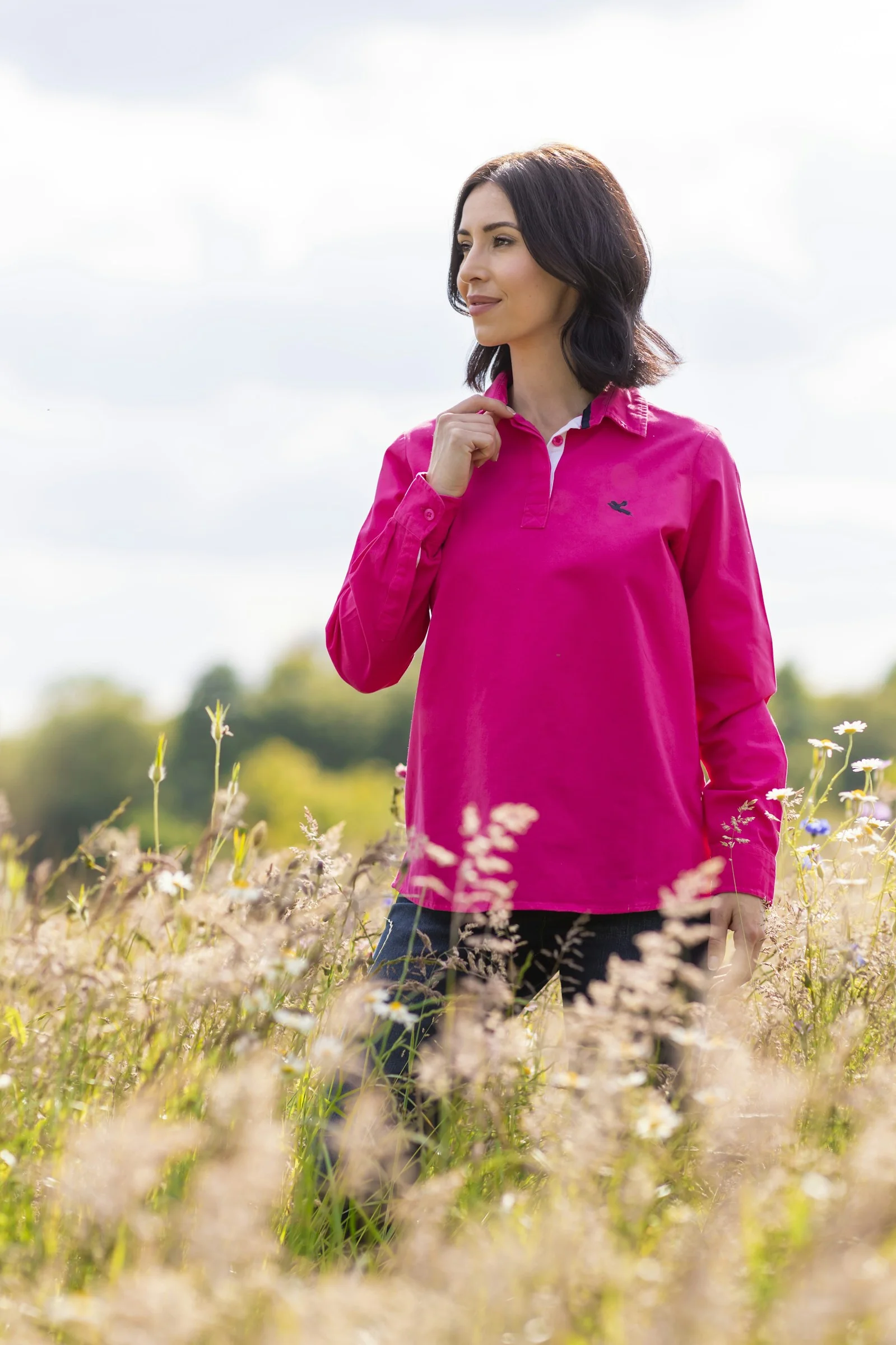 A woman standing in a field of tall grass