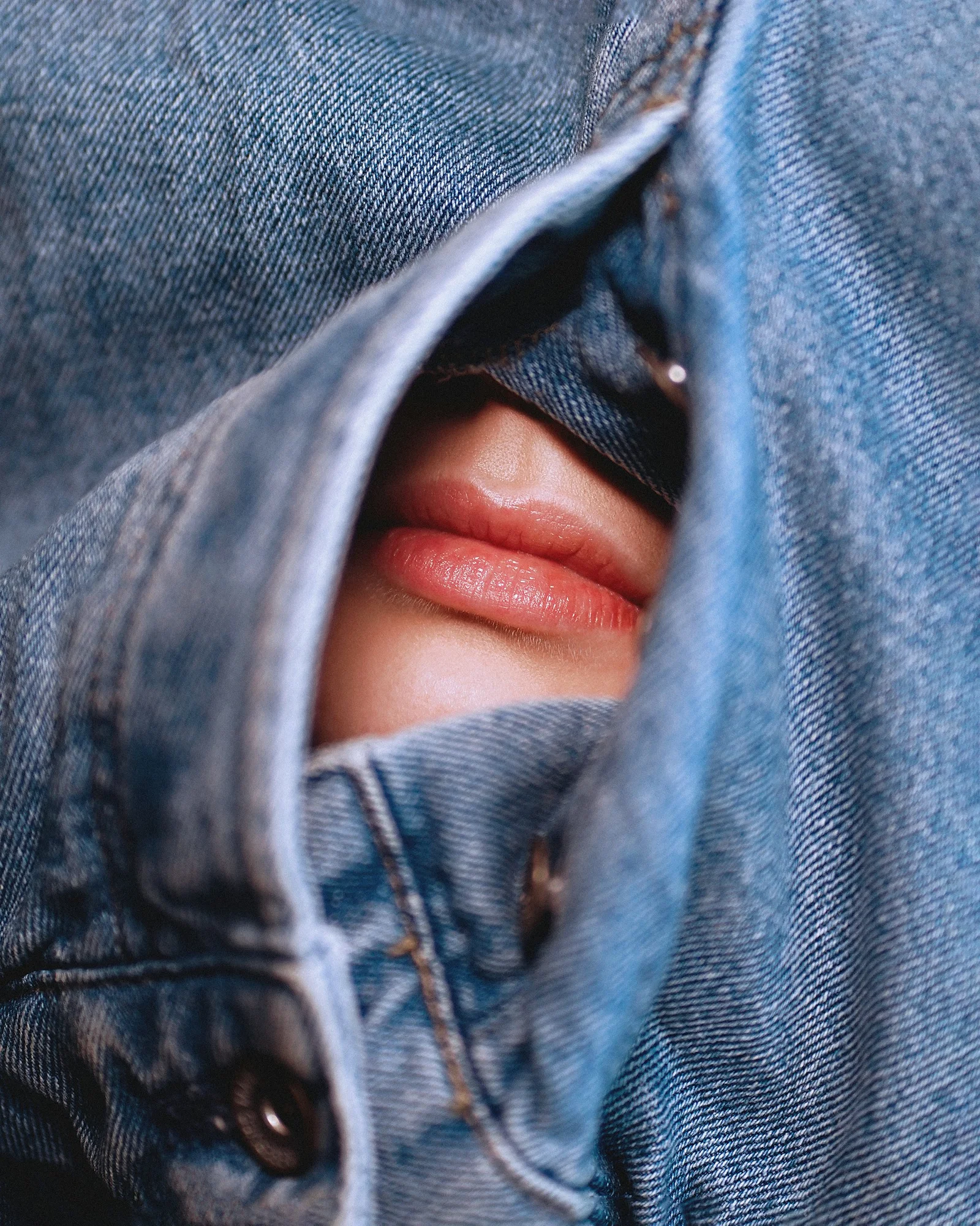 a person's face in a pair of jeans