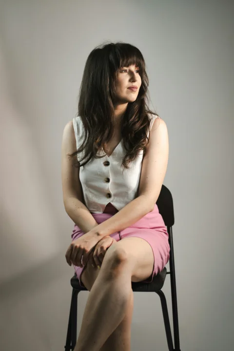 A woman is sitting and looking away