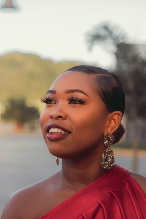 a woman in a red dress is smiling