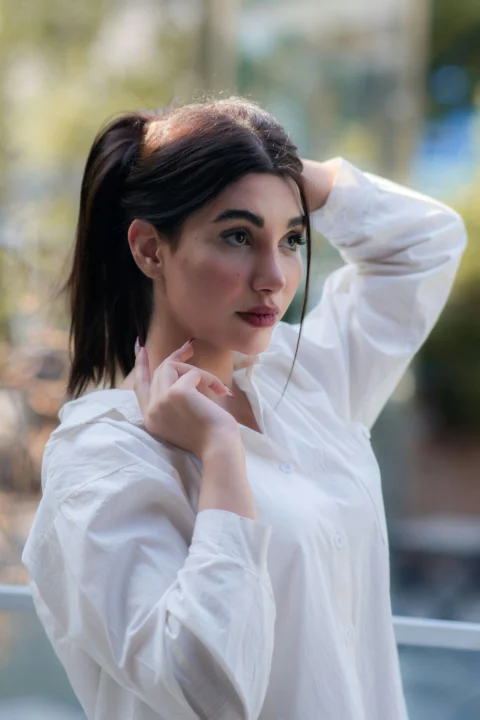 A woman with dark hair in a white shirt