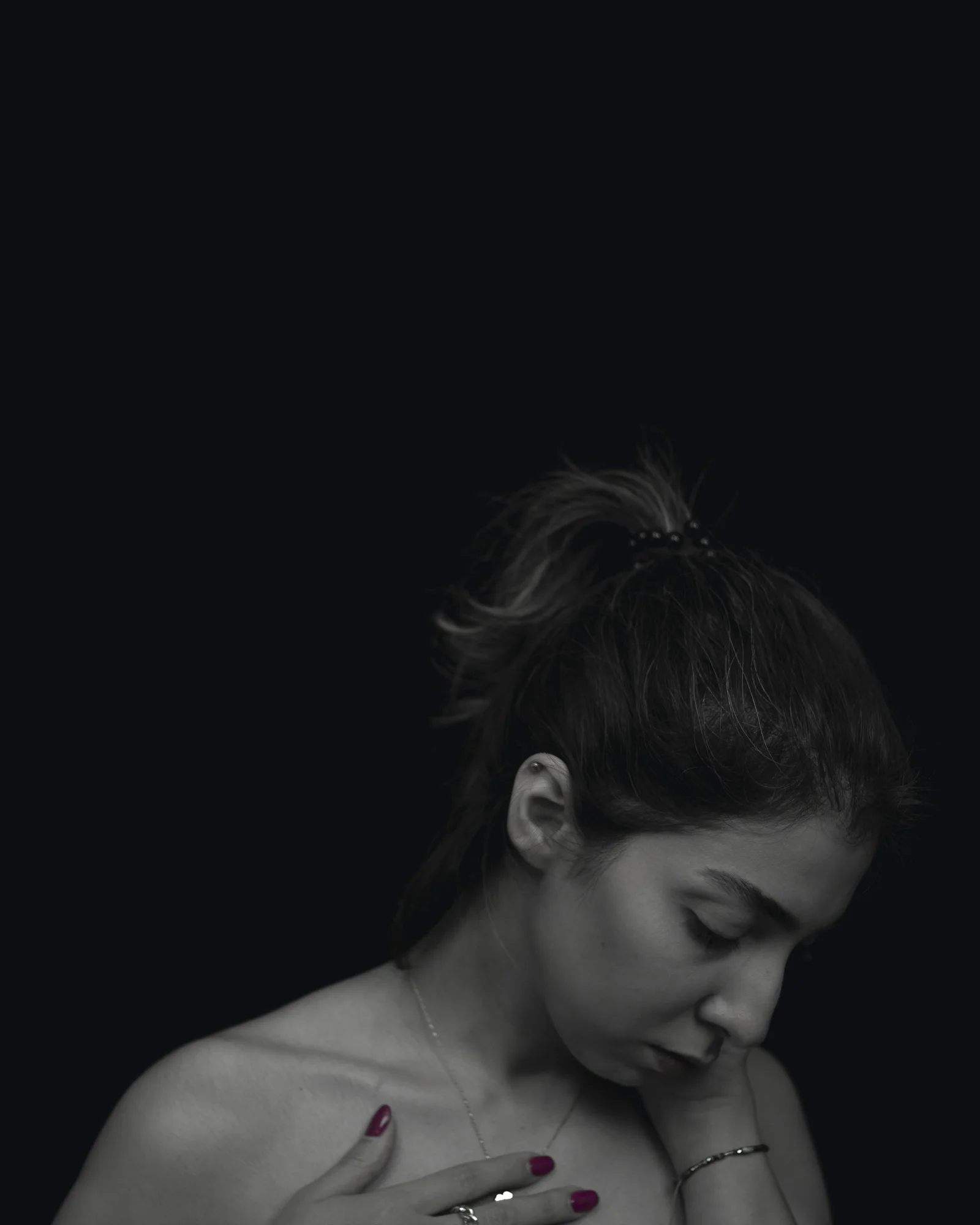 a woman in a black and white photo holding a cell phone