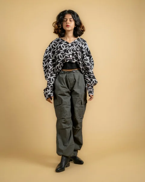 a woman standing in front of a brown background