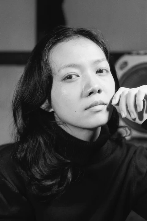 A black and white photo of a woman brushing her hair