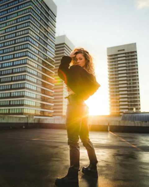 woman in yellow long sleeve shirt and brown pants standing on road during daytime