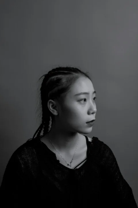 greyscale photography of woman facing at right sied