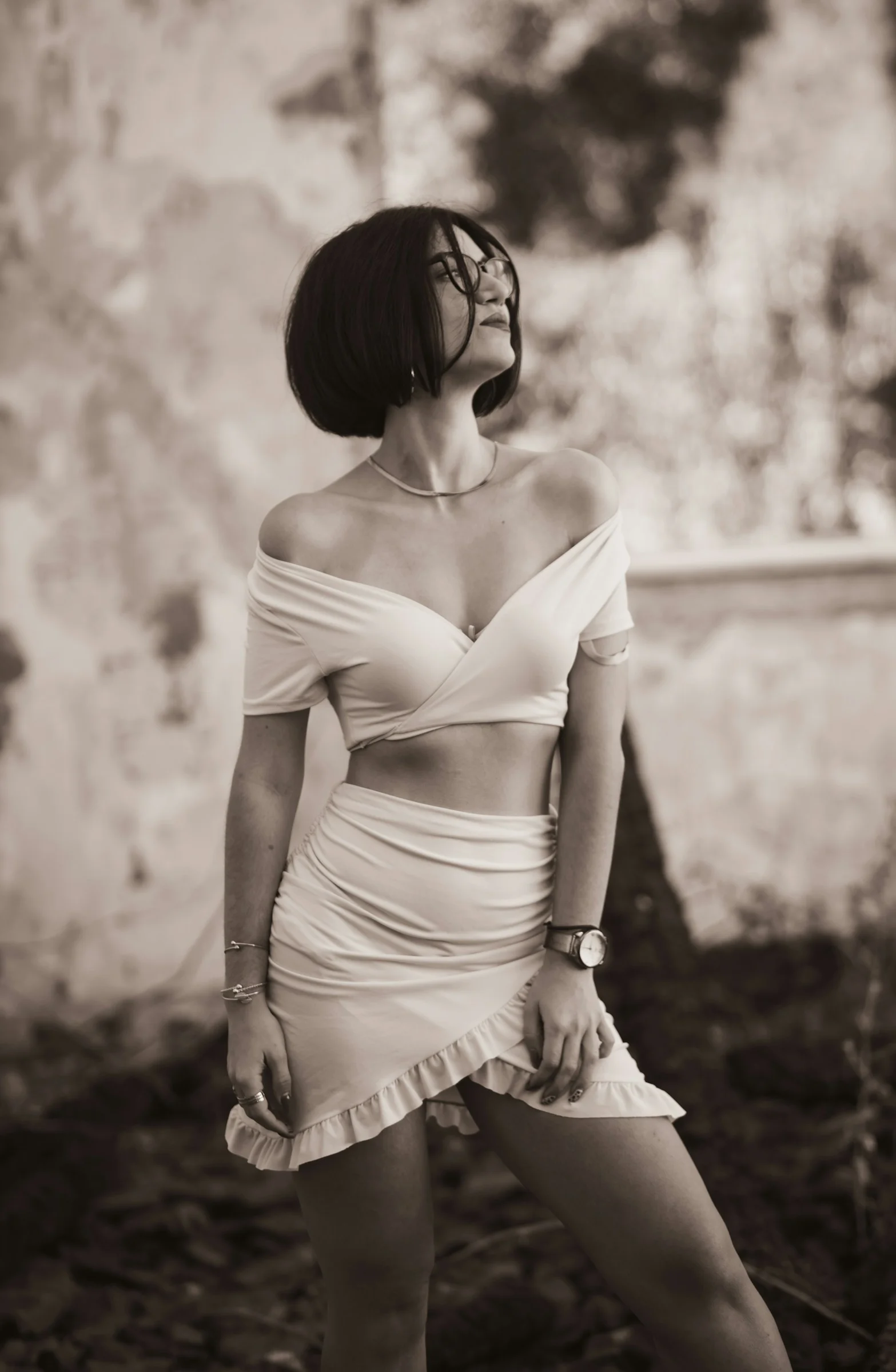 a woman in a white dress posing for a picture