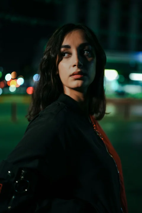 Young woman with dark hair at night