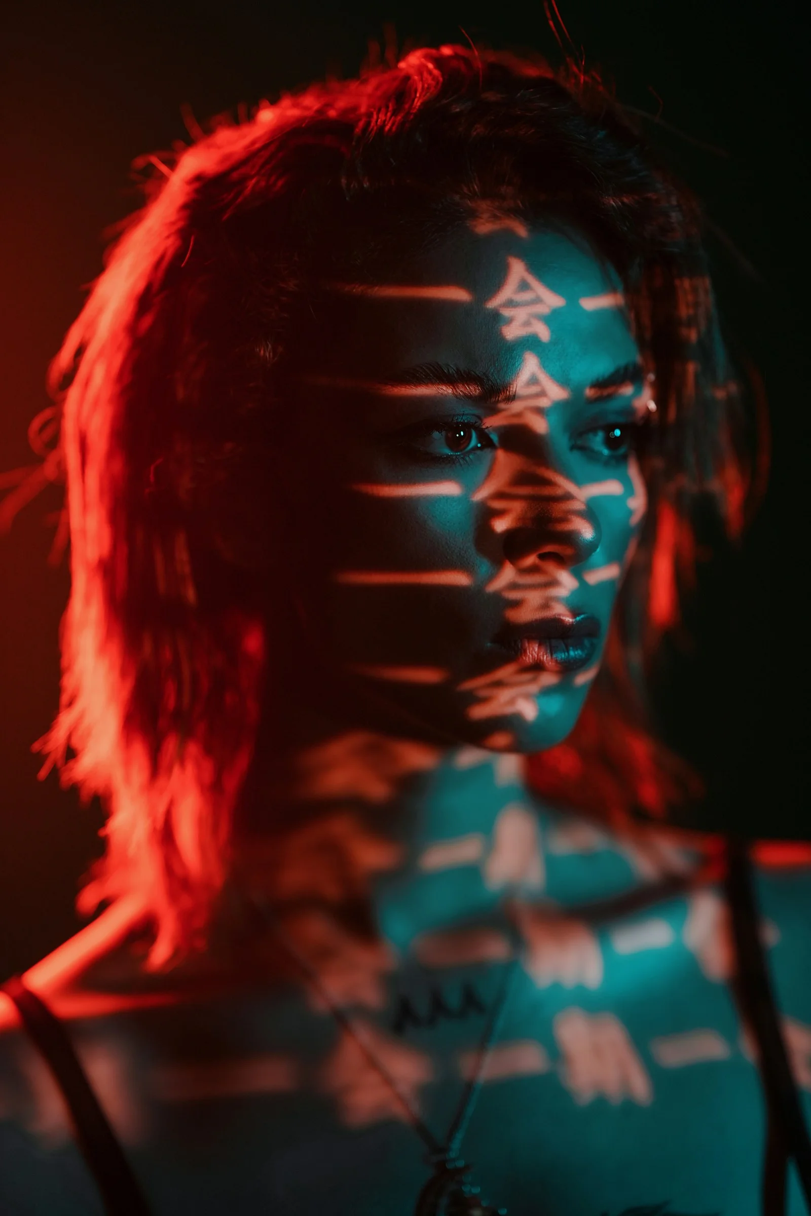 A woman's face is illuminated with projections