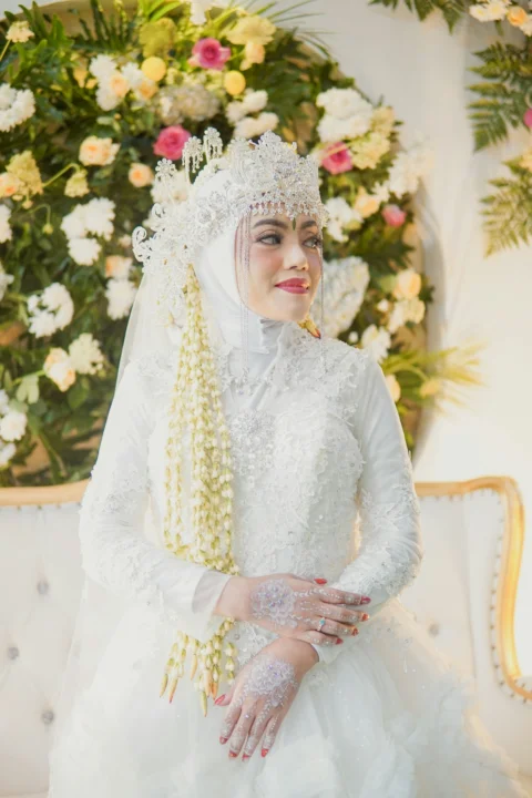 woman in white floral dress wearing white floral hijab