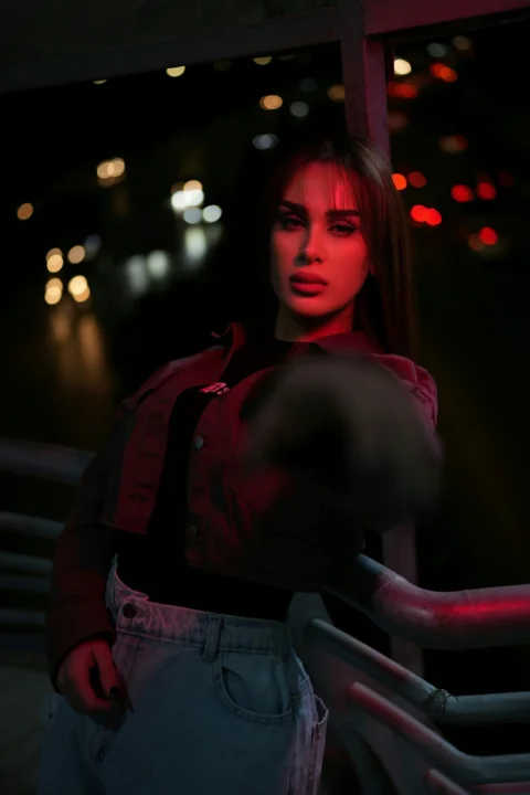 Woman illuminated by red light at night