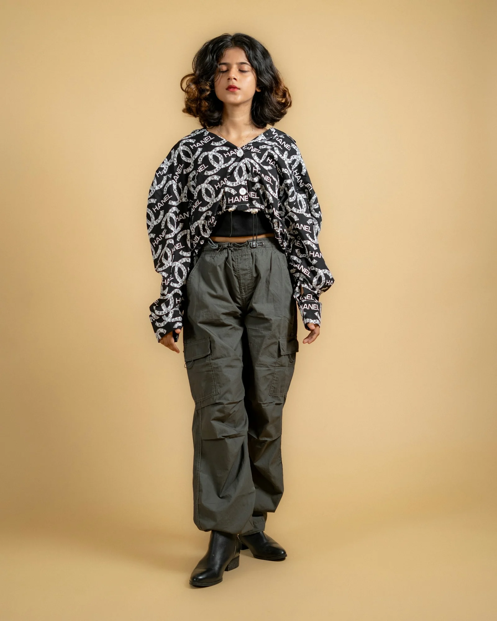 a woman standing in front of a brown background