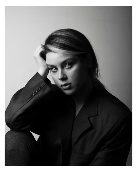 A black and white photo of a woman in a suit