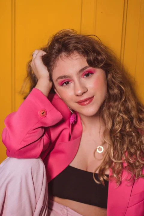 woman in pink blazer smiling