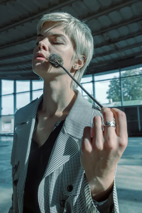 woman in black and white checkered blazer holding microphone