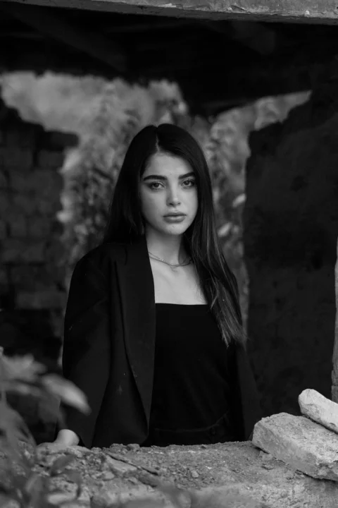 Young woman with dark hair looking at camera