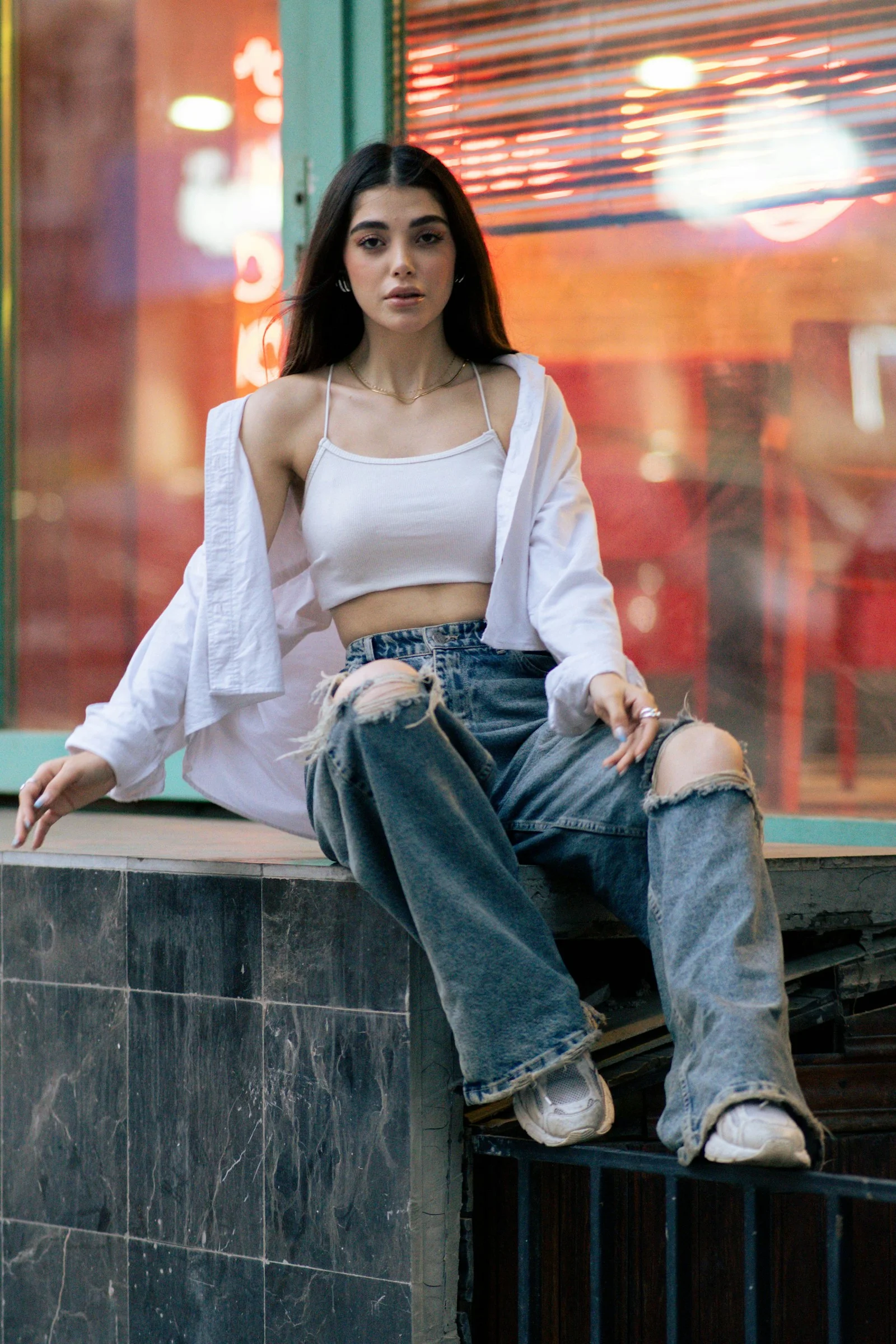 A fashionable woman posing by a window