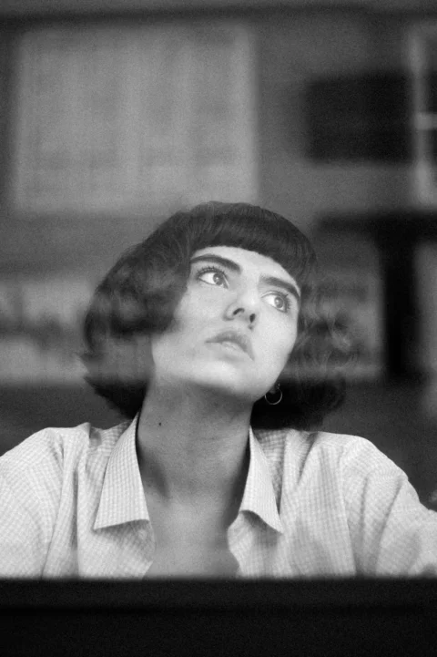 A woman gazes upward, lost in thought