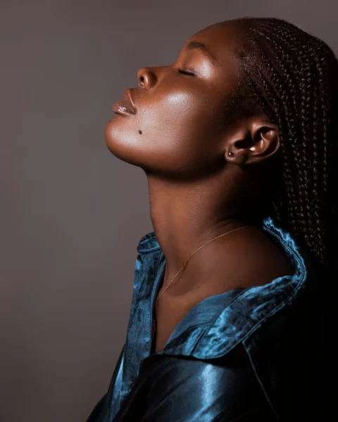 A woman with braids looking up into the sky