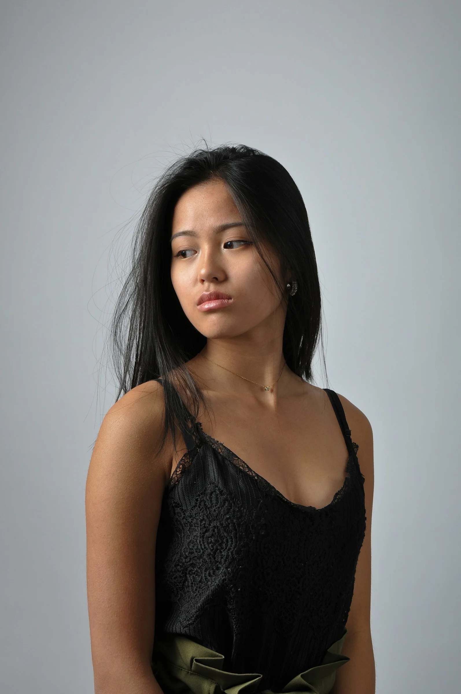 a woman in a black top is posing for a picture