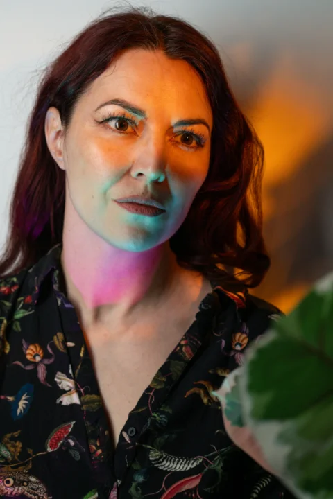 Woman's portrait with colorful, dramatic lighting