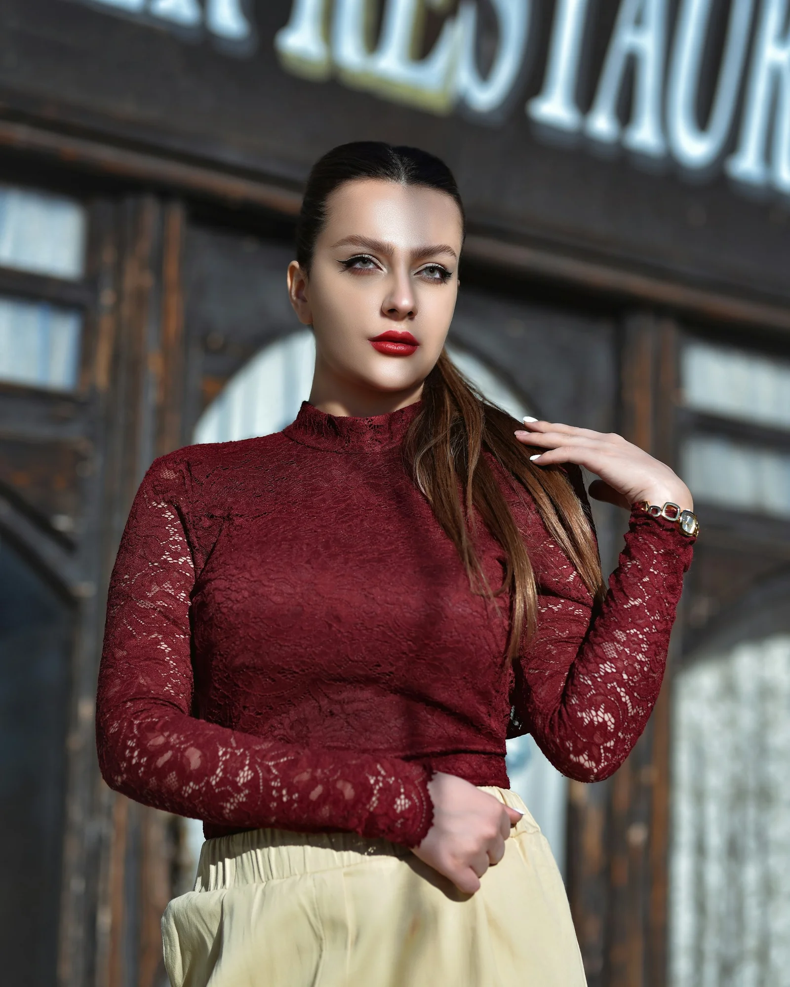 woman in red long sleeve shirt and white skirt
