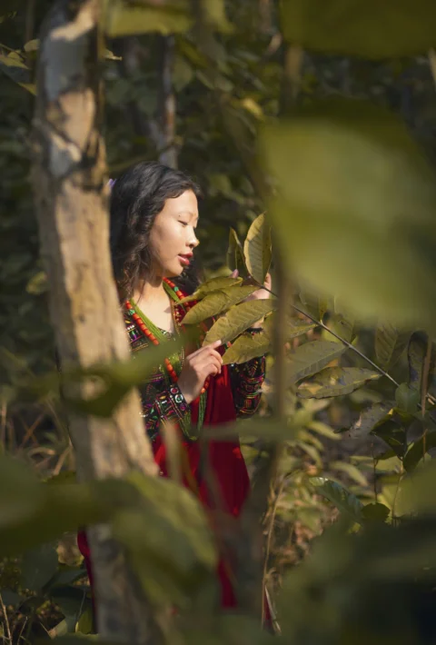 Young woman in traditional clothing in a forest