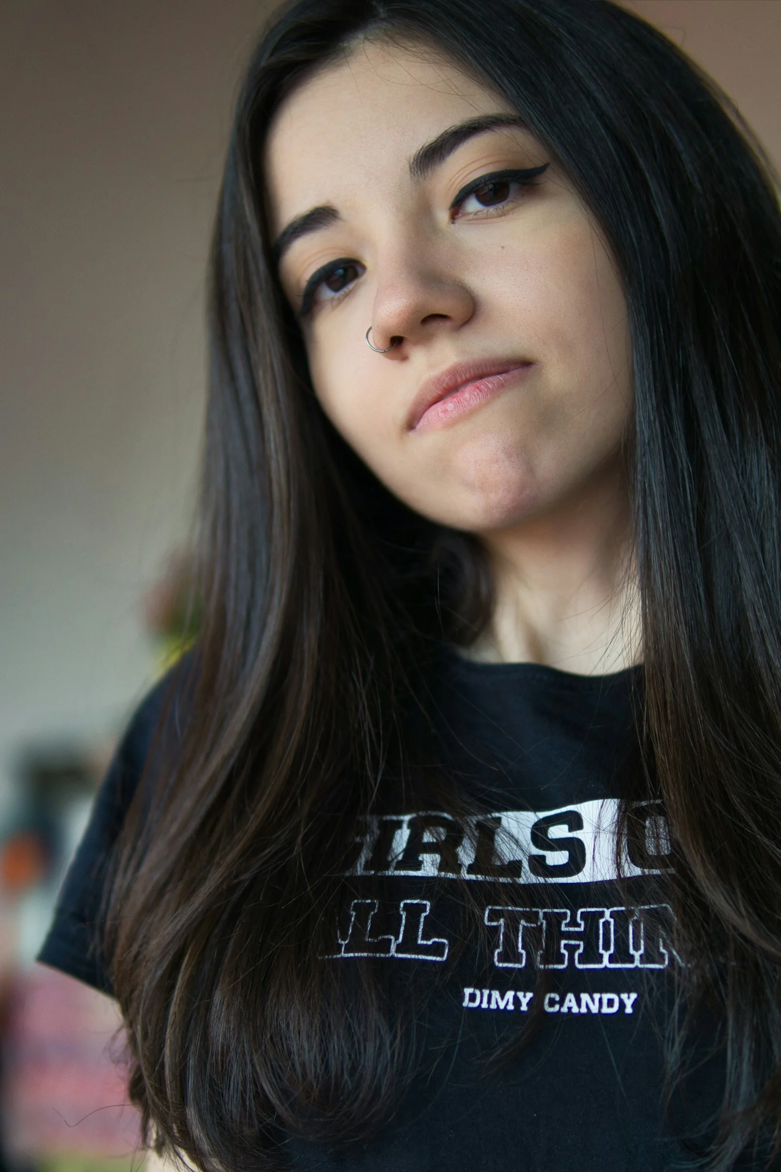 a woman with long black hair wearing a black shirt