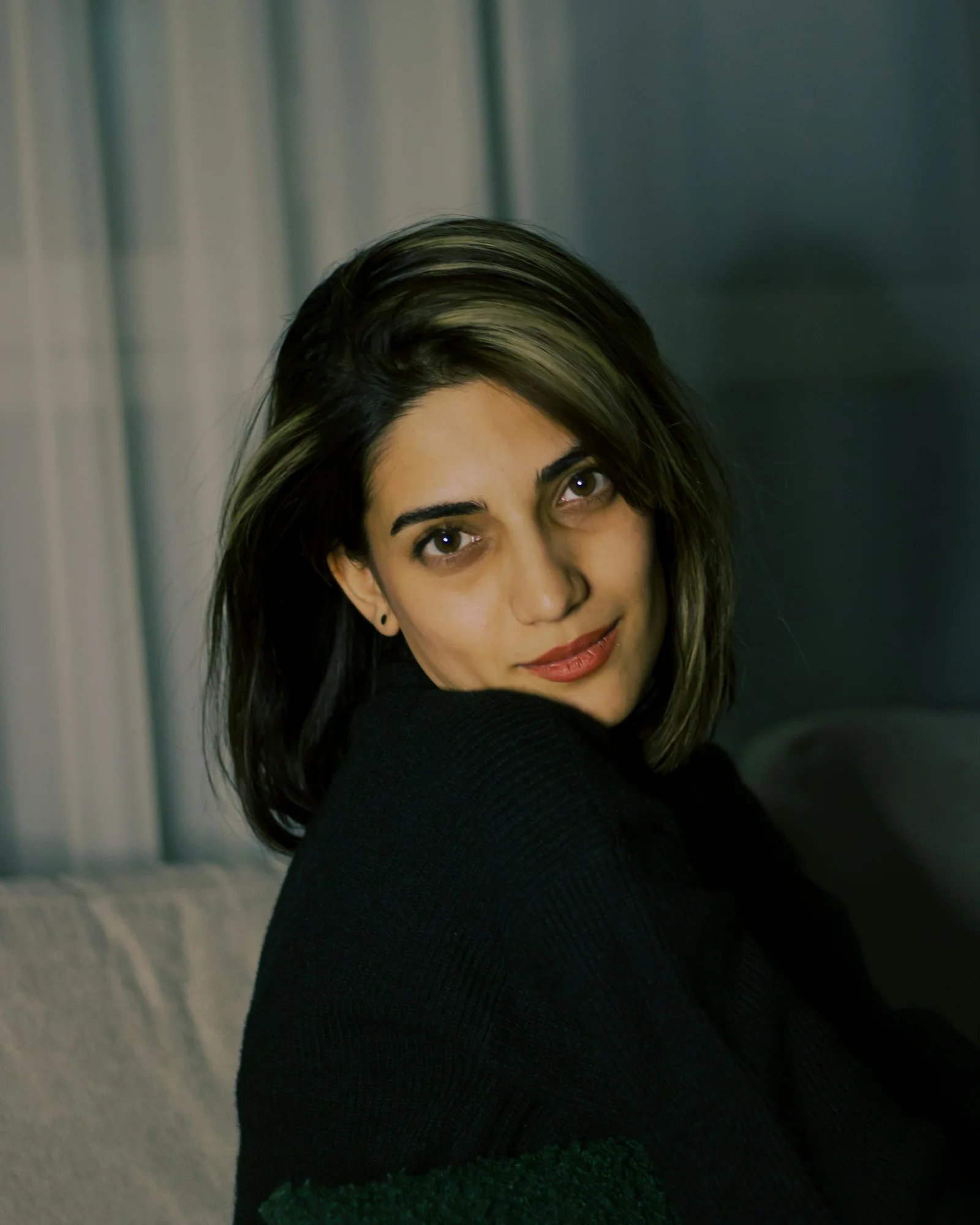 A woman sitting on top of a white couch